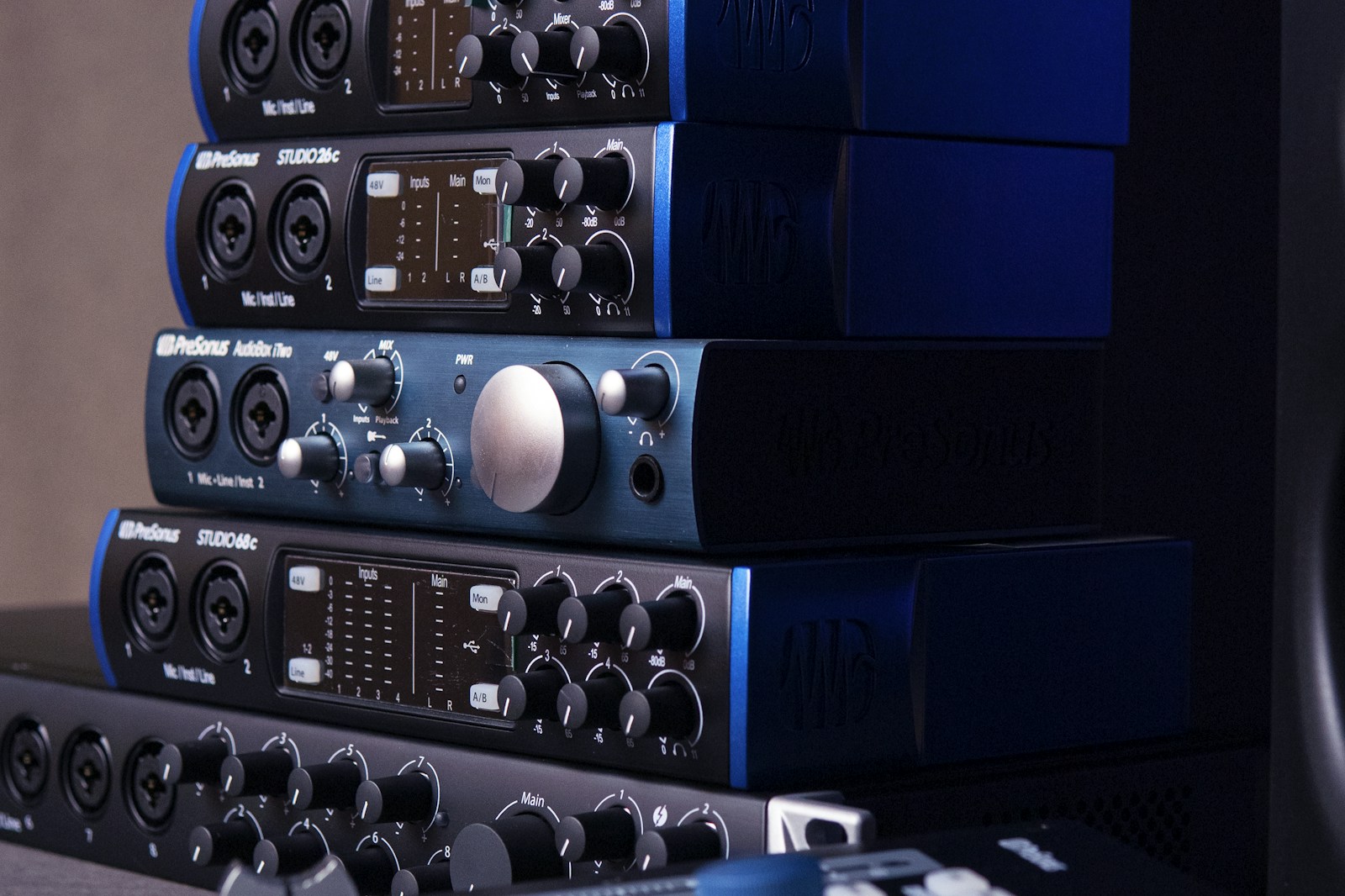 Close-up of an audio interface rear panel showing labeled XLR and TRS input and output jacks