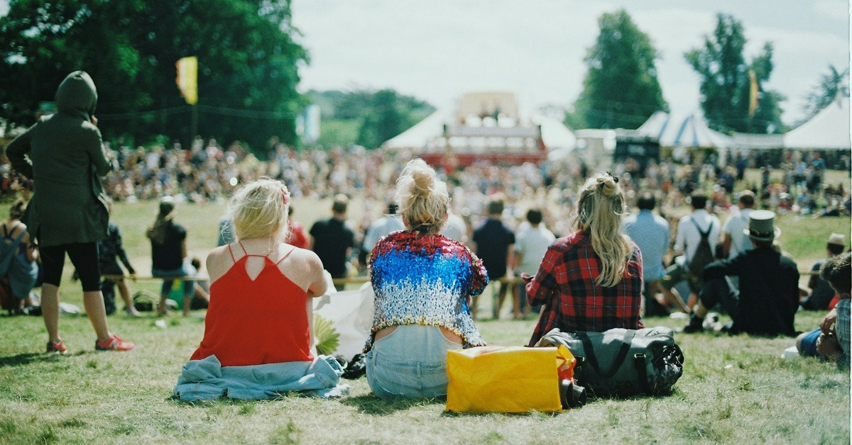 Two DJs sharing the decks at a festival booth, preparing for a B2B set