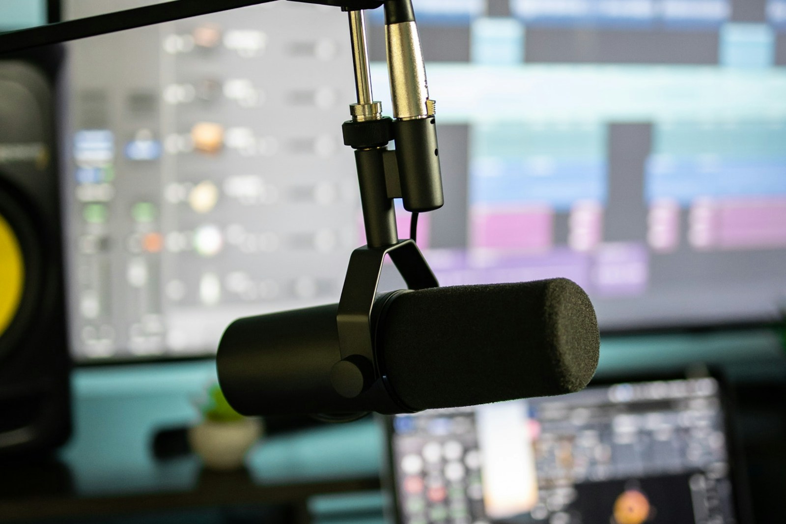 Close up of an audio interface and condenser microphone on a desk in a home studio