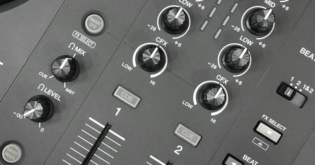 Pioneer DJ DDJ-FLX10 controller placed on a DJ booth with a laptop and headphones
