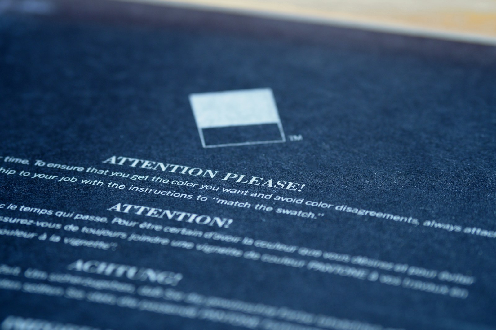 A disclaimer notice document with a signature and a red approval stamp on a wooden table