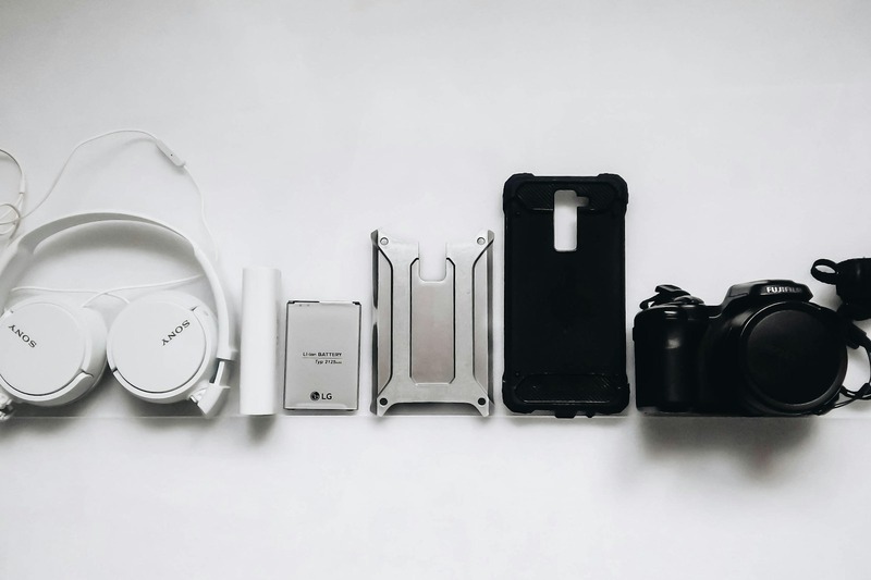 A collection of DJ accessories including a padded carrying case, closed-back headphones, and various cables laid out on a table