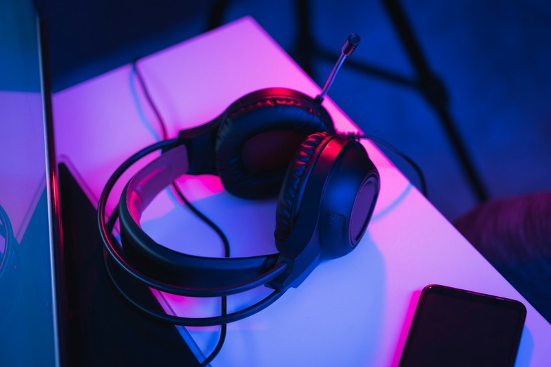 DJ accessories including headphones and cables next to a controller