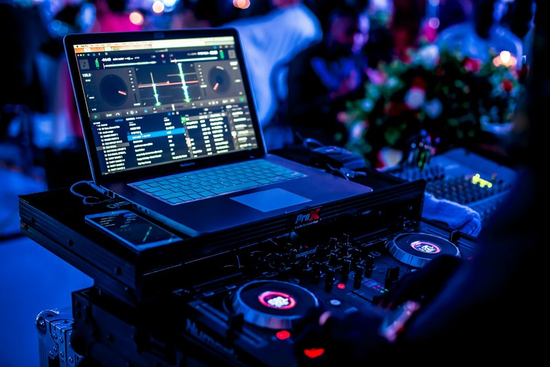 Professional DJ setup in a club booth with a digital mixer and CDJ players