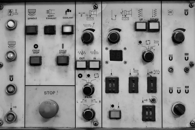 Internal view of a DJ controller with exposed faders and circuit board