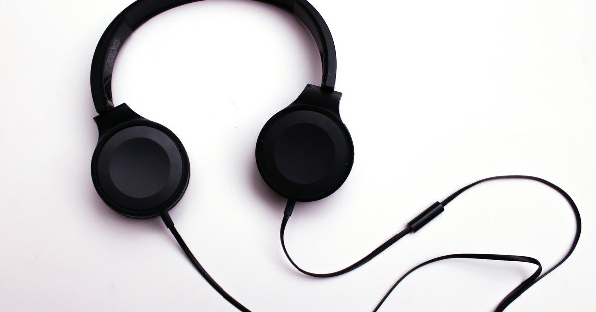 DJ toolkit with headphones, USB drives, and XLR cables arranged on a table