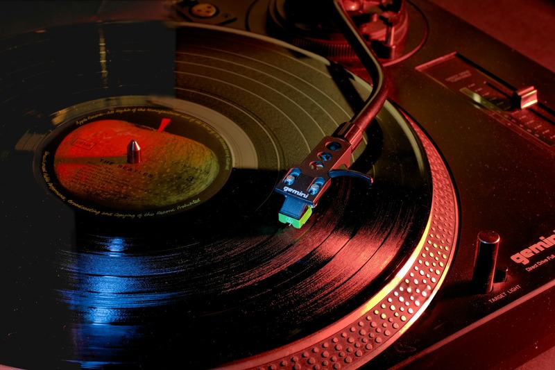 Comparison of two pairs of DJ gloves placed side by side on a turntable
