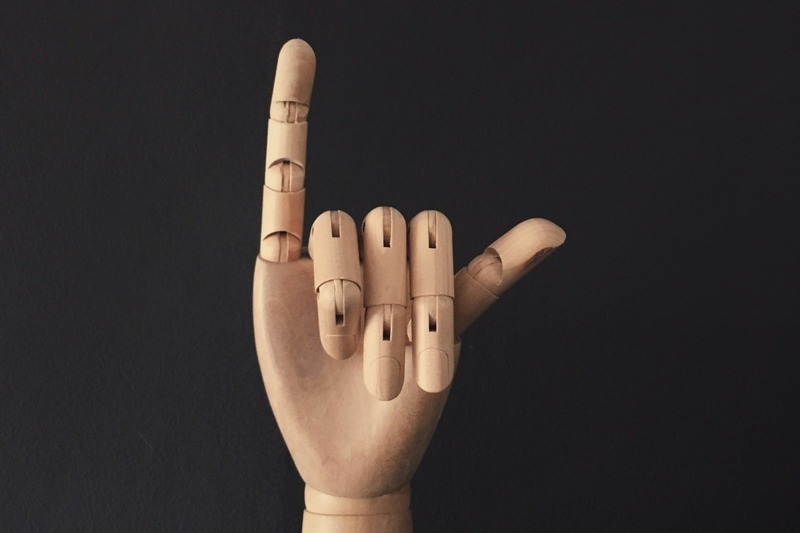 DJ making a hand signal to communicate during a B2B set