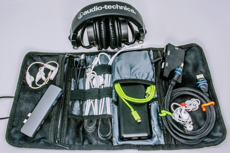 DJ headphones and cable management accessories organized in a padded travel case