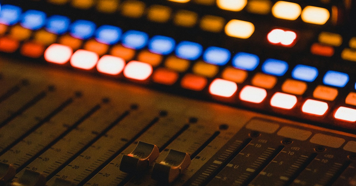 Music producer working with a drum machine plugin in a digital audio workstation studio setup