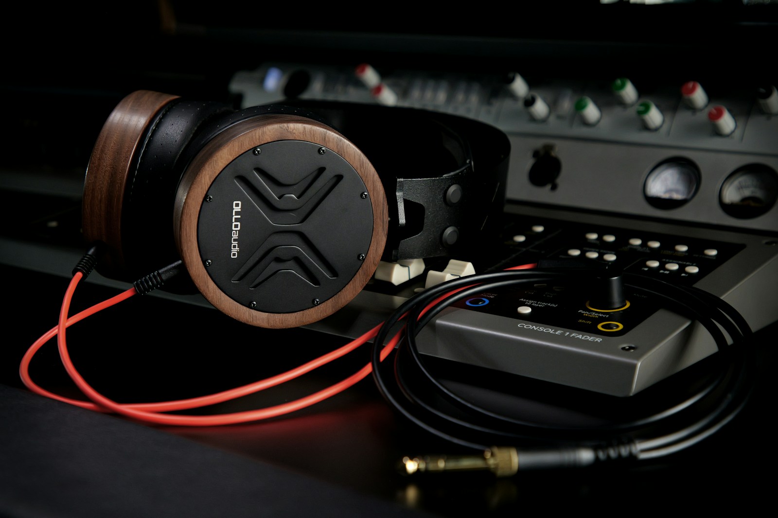 A collection of essential home studio gear including microphones, headphones, and XLR cables laid out on a table.