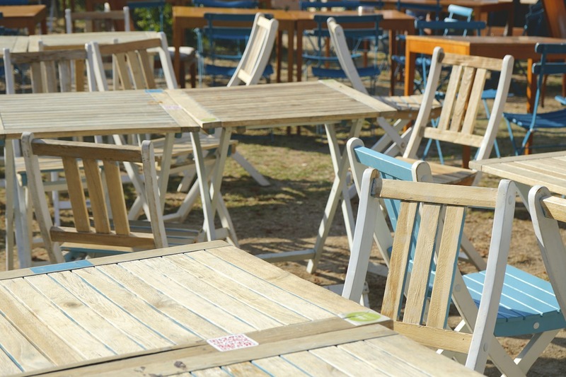Paper festival map and fabric wristband placed on a weathered wooden table
