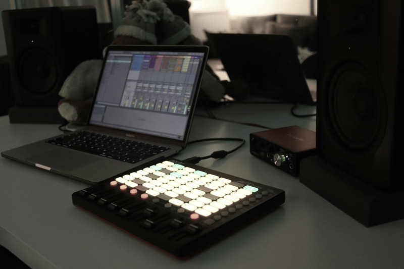 MIDI controller keyboard placed in front of a laptop running Ableton Live