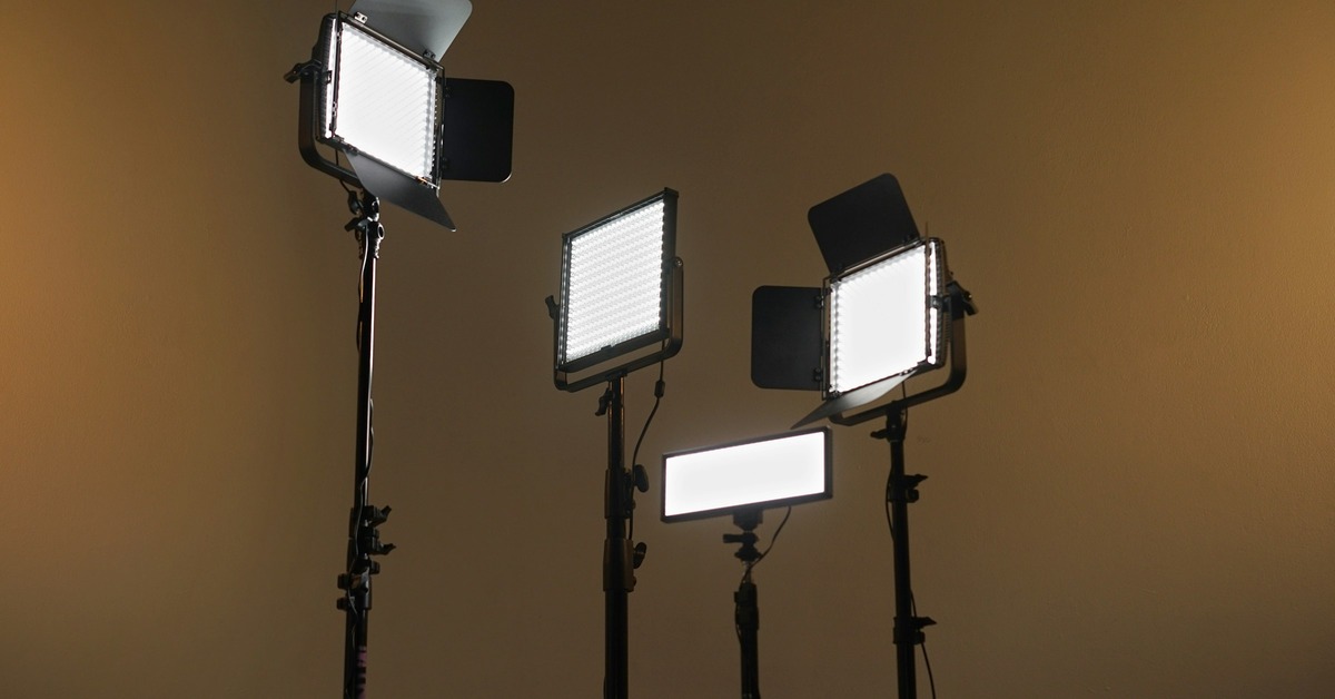 Mobile DJ lighting setup with par can lights mounted on stands in a venue