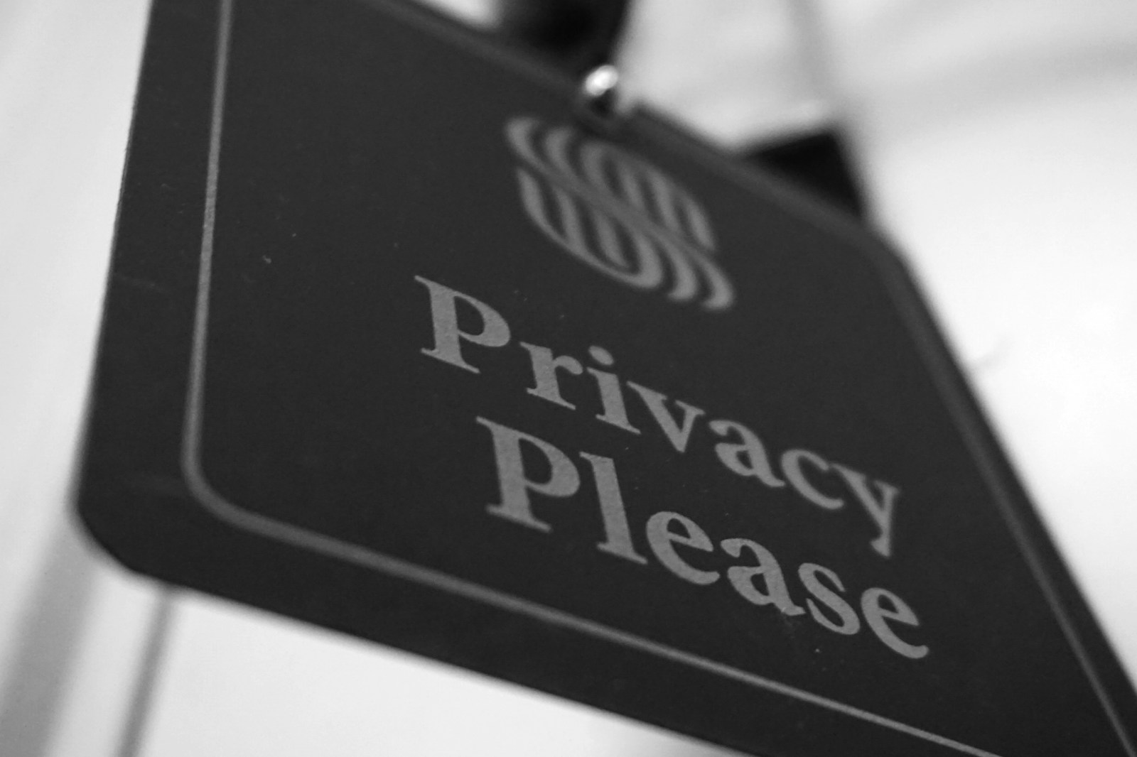 Privacy policy document on a wooden desk next to a coffee cup and reading glasses