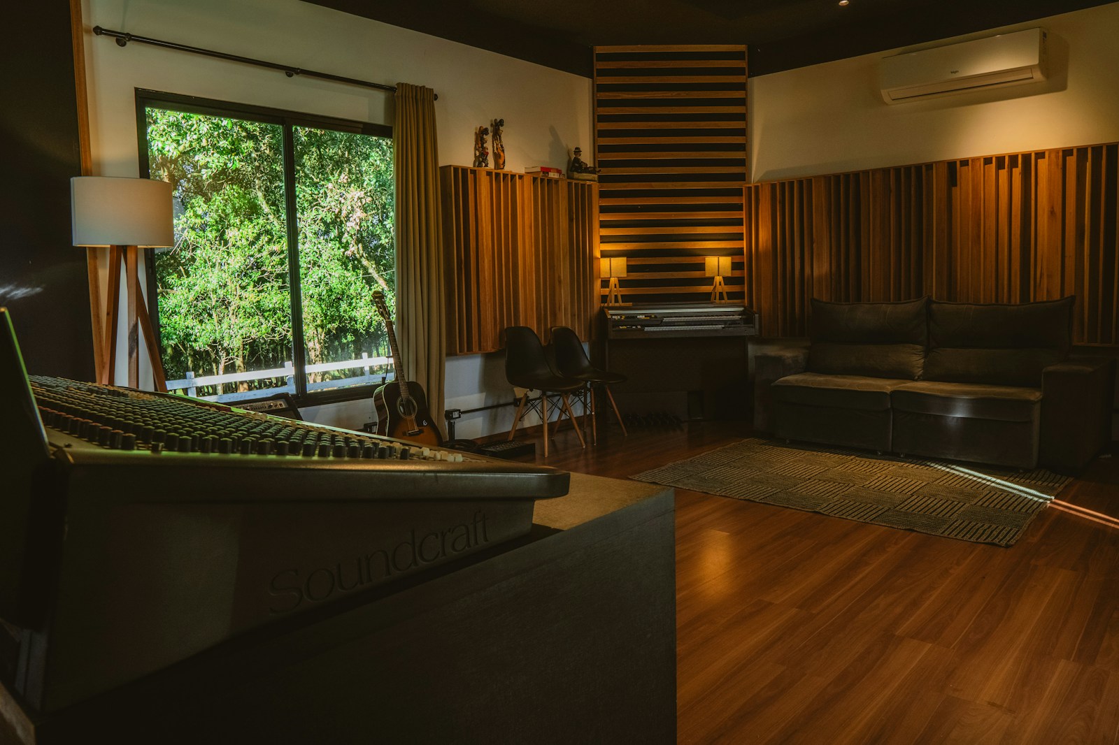 Professional mixing studio room with acoustic panels on walls, bass traps in corners, and monitors placed on stands with proper positioning.