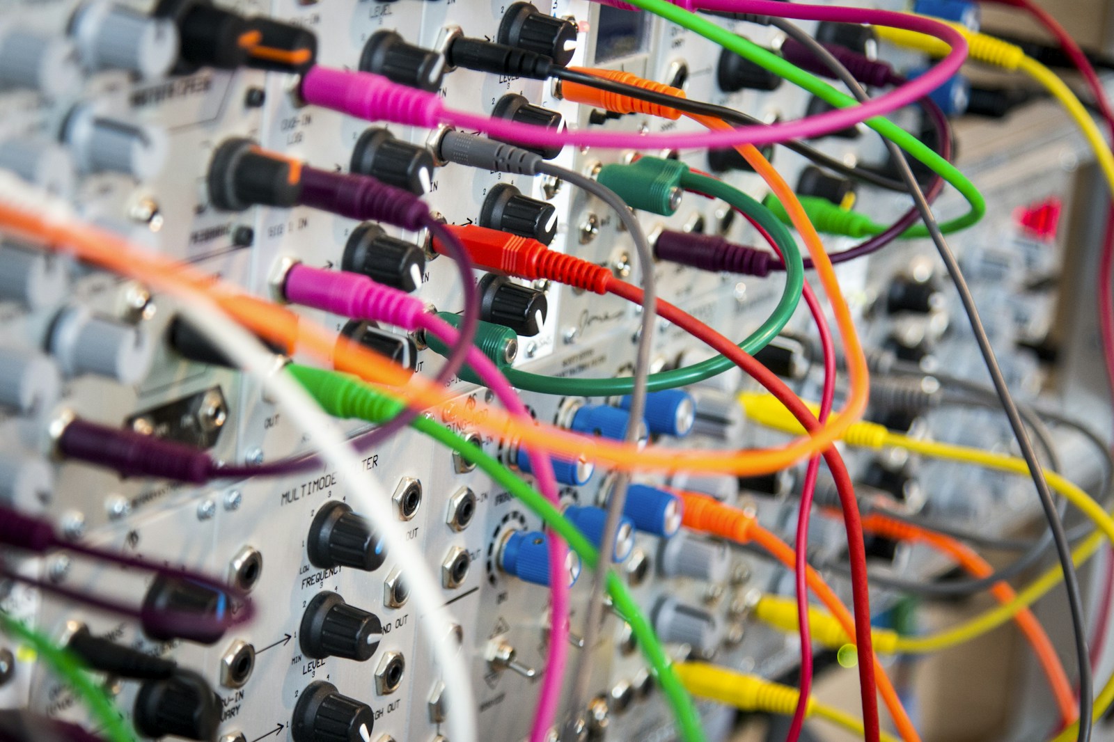 Rack of studio gear with cables connected and a signal flow diagram overlay showing the audio path