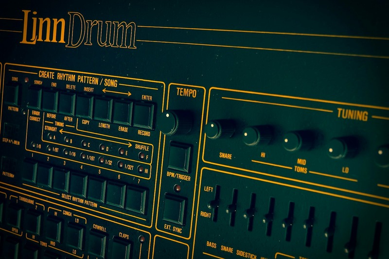 Roland TR-808 drum machine plugin interface open on a computer screen in a music studio