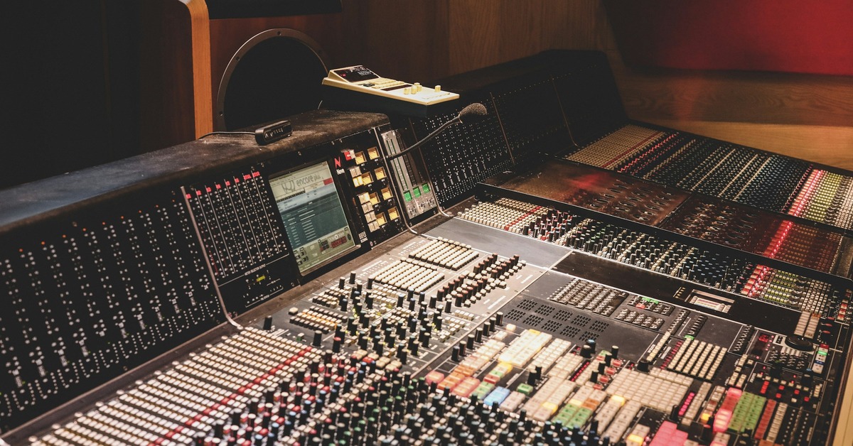 Studio mixing desk with monitor speakers and headphones ready for a mixing session