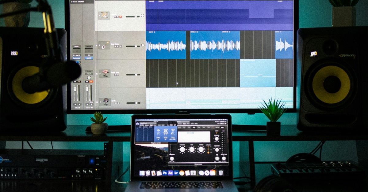 Home studio vocal recording chain setup with microphone, audio interface, and headphones arranged on a desk